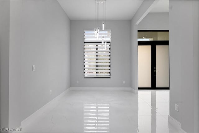 unfurnished room featuring french doors