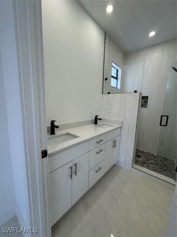 bathroom featuring walk in shower and vanity