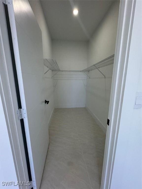 spacious closet with light tile patterned flooring