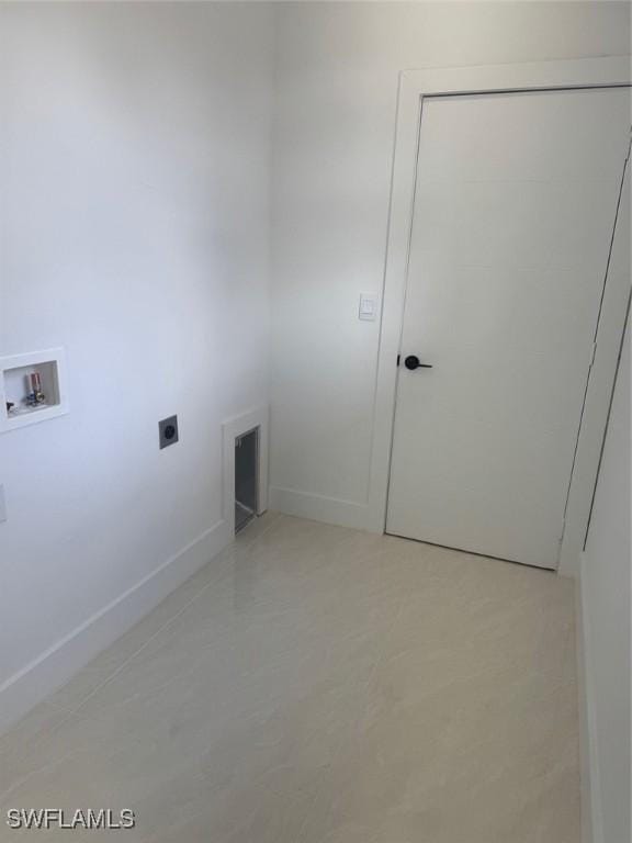 laundry area with laundry area, hookup for a washing machine, electric dryer hookup, and baseboards