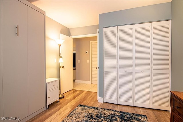 bedroom featuring light hardwood / wood-style floors and a closet