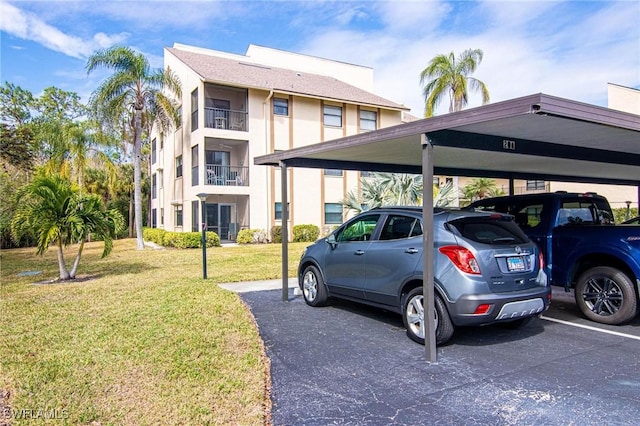 view of car parking with a lawn and a carport