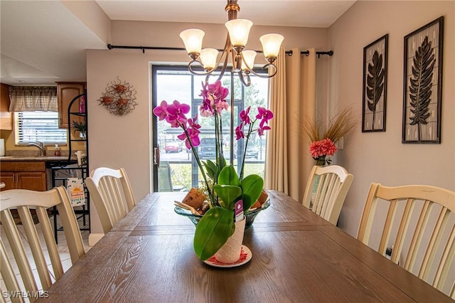 dining room featuring sink and an inviting chandelier