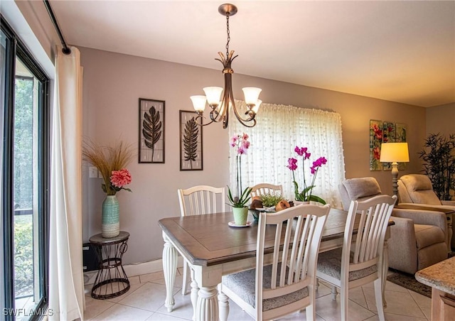 tiled dining room featuring a chandelier