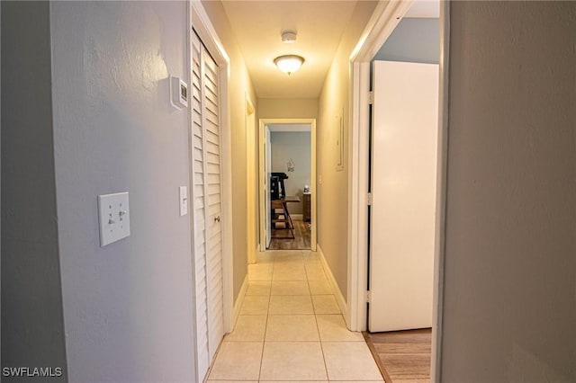 hallway featuring light tile patterned floors