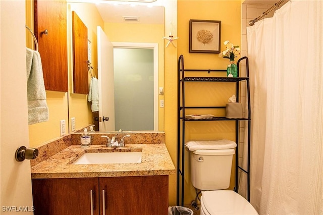 bathroom with toilet and vanity