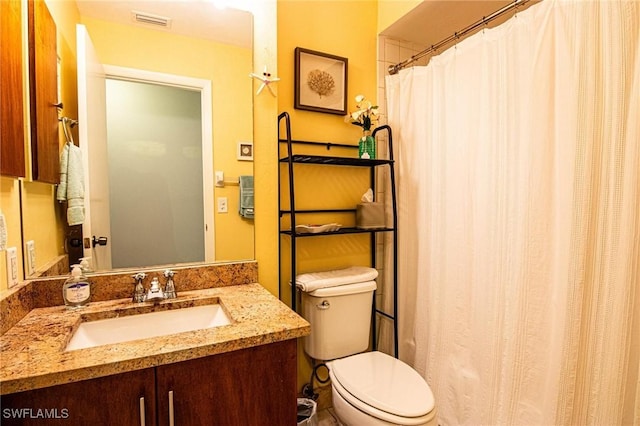 bathroom featuring toilet and vanity