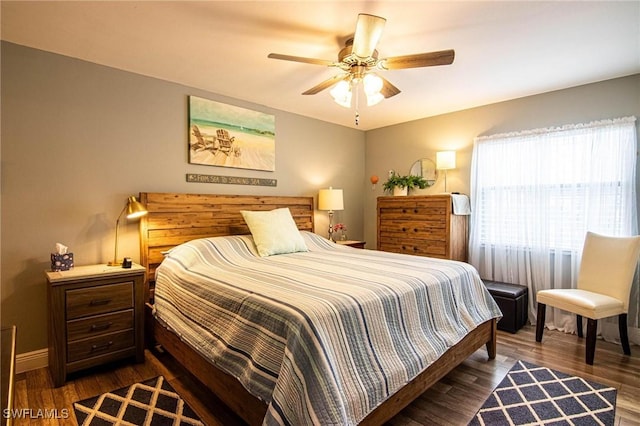 bedroom with ceiling fan and dark wood-type flooring