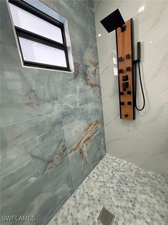 bathroom with a tile shower