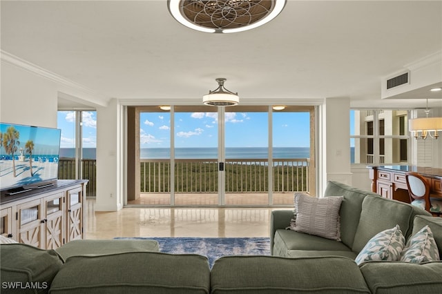 living room featuring a water view, expansive windows, a notable chandelier, and crown molding