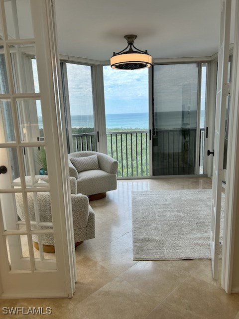 unfurnished sunroom with a water view