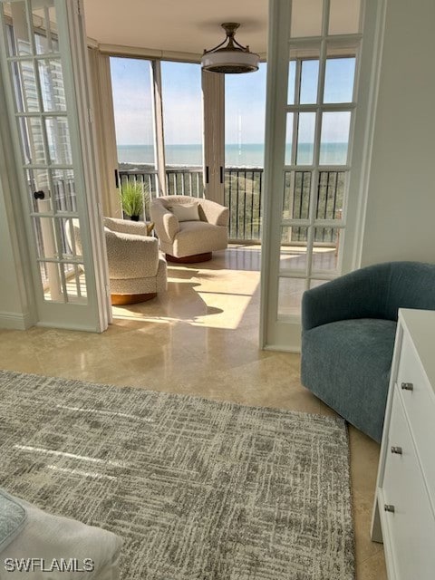 living area featuring a water view and expansive windows