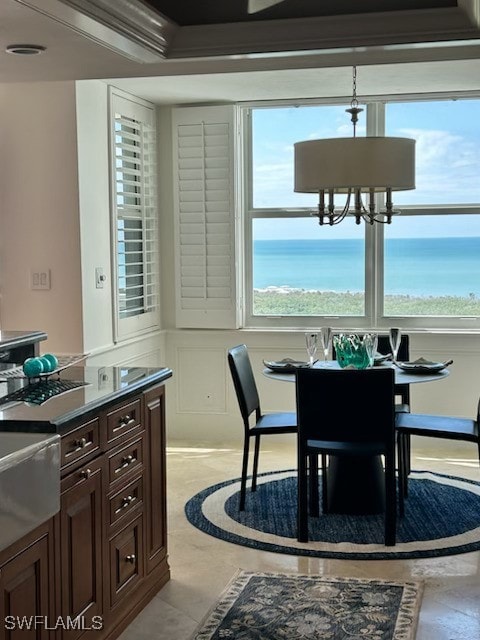 6573 Marissa Loop Unit 2004, Naples, FL 34108 - dining area with a decorative wall and a chandelier