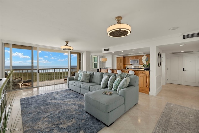 6573 Marissa Loop Unit 2004, Naples, FL 34108 - living room with floor to ceiling windows and a water view