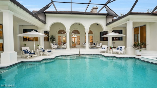 view of pool featuring a patio area, a lanai, and french doors