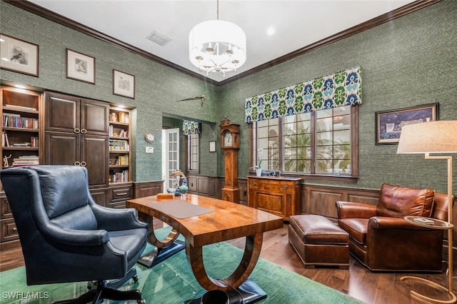 office space featuring a notable chandelier, crown molding, and hardwood / wood-style floors