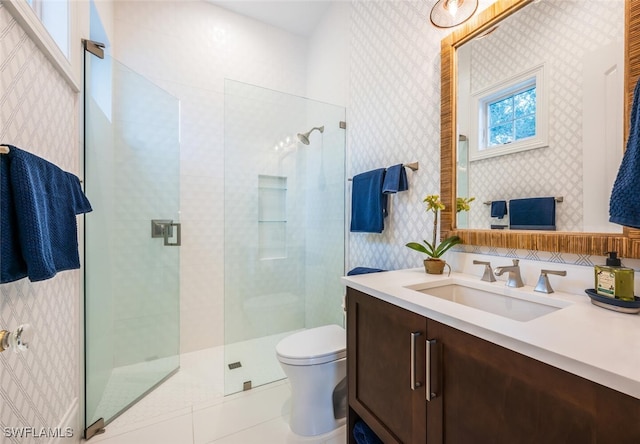 bathroom with a shower with shower door, toilet, and vanity