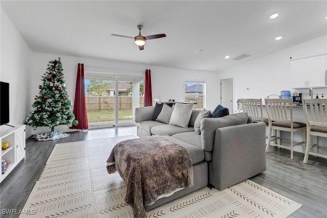 living room featuring ceiling fan and light wood-type flooring