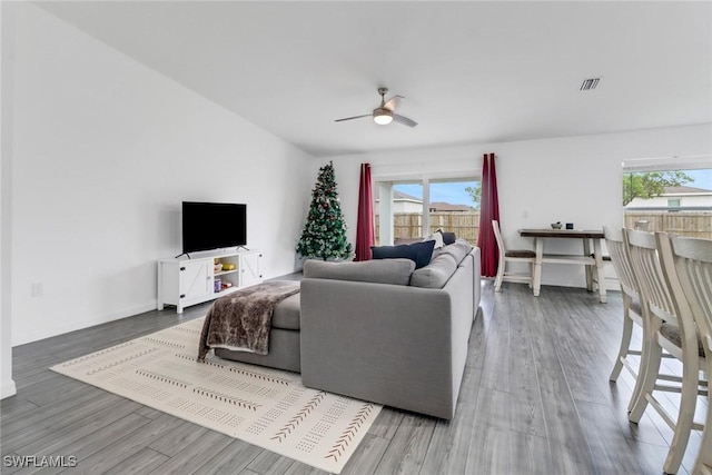 living room featuring ceiling fan and wood-type flooring