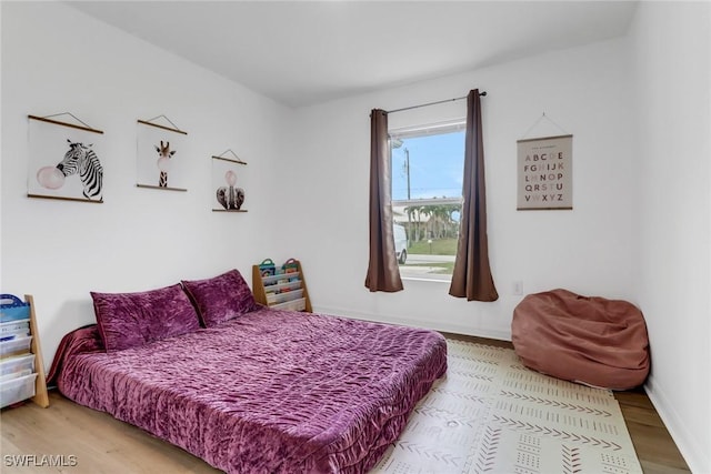 bedroom with hardwood / wood-style flooring