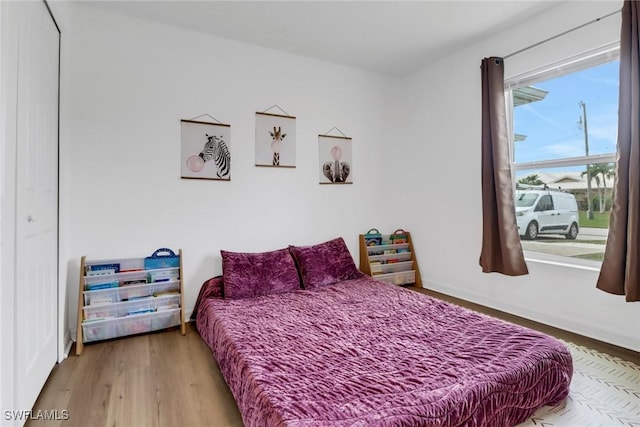 bedroom with a closet and hardwood / wood-style floors