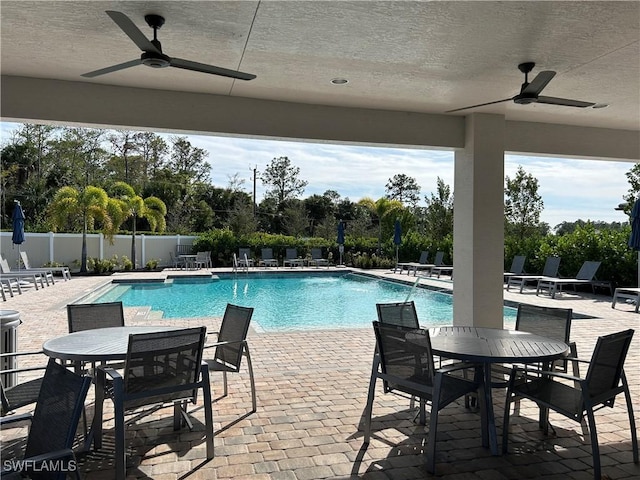 view of pool with ceiling fan and a patio