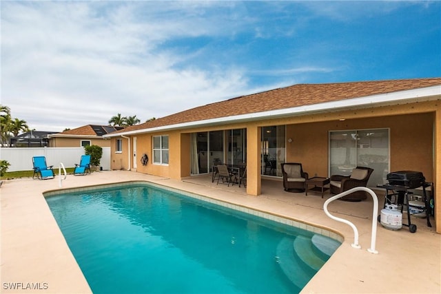 view of swimming pool featuring grilling area and a patio