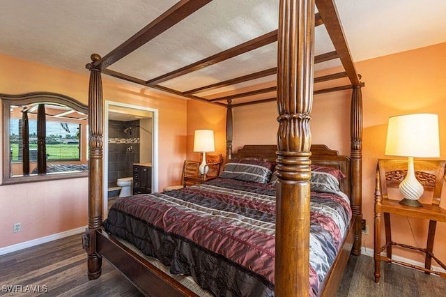 bedroom with ensuite bathroom and dark hardwood / wood-style floors