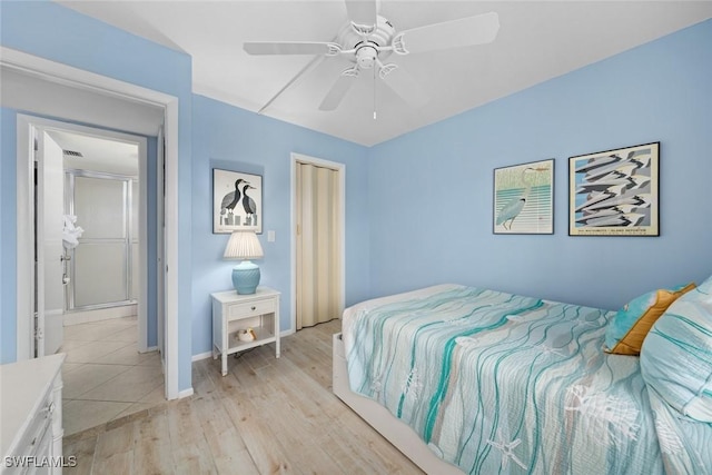 bedroom with light wood finished floors, a closet, a ceiling fan, and baseboards