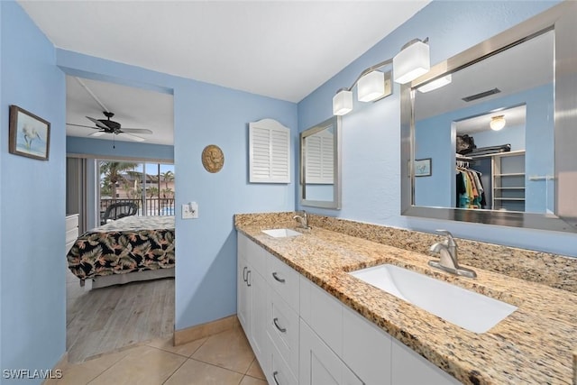 full bath featuring a spacious closet, tile patterned flooring, a sink, and visible vents