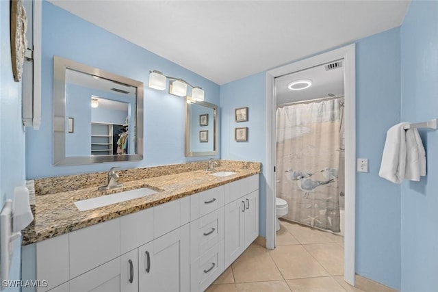 bathroom featuring tile patterned flooring, a shower with curtain, a sink, and toilet