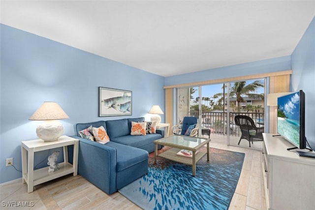 living room with light wood-style flooring and baseboards