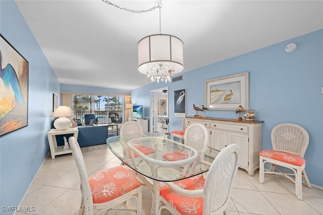 dining room with a chandelier, visible vents, baseboards, and light tile patterned floors