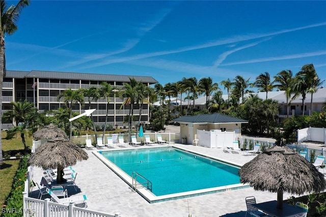 community pool featuring a patio area and fence