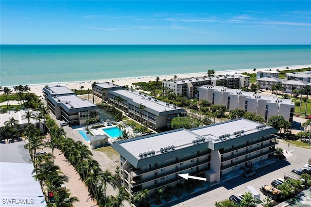 birds eye view of property with a water view and a view of the beach