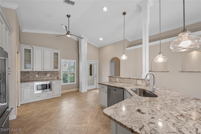 kitchen featuring white cabinetry, ceiling fan, appliances with stainless steel finishes, pendant lighting, and sink