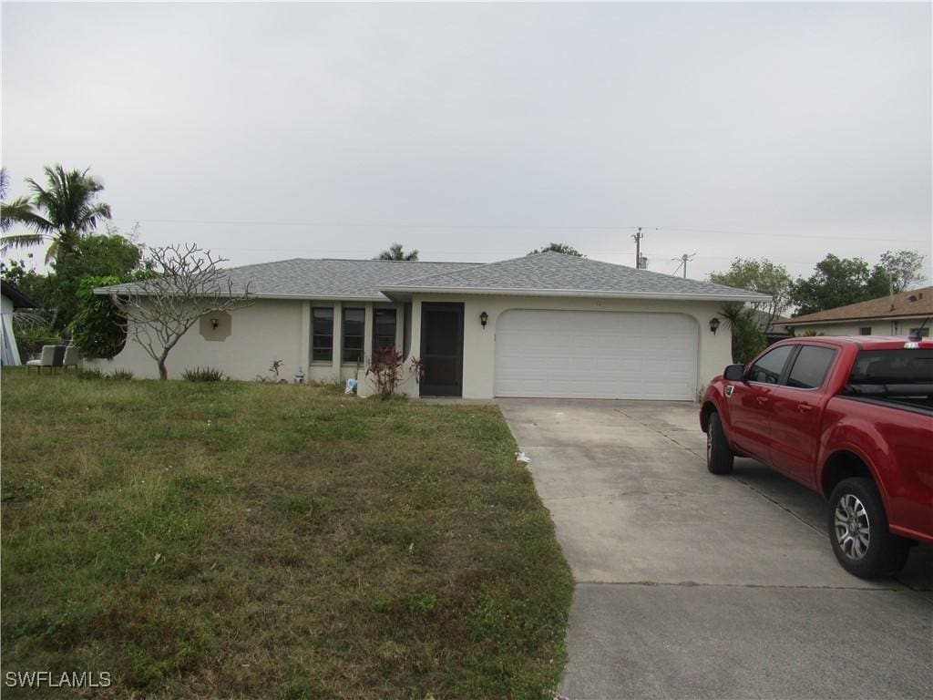 ranch-style house with a front yard and a garage