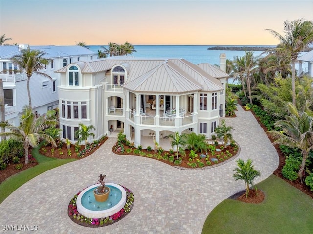 view of front of property featuring a water view and a balcony