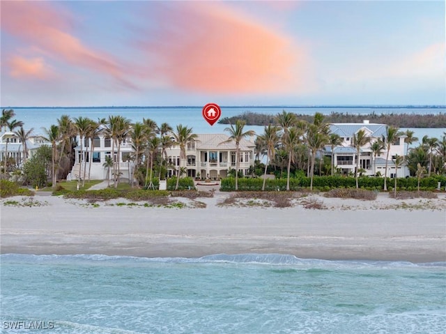 exterior space with a water view and a beach view