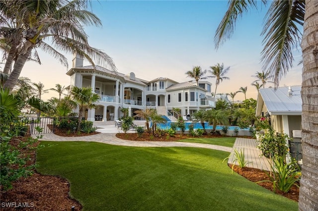 exterior space featuring a balcony and a pool