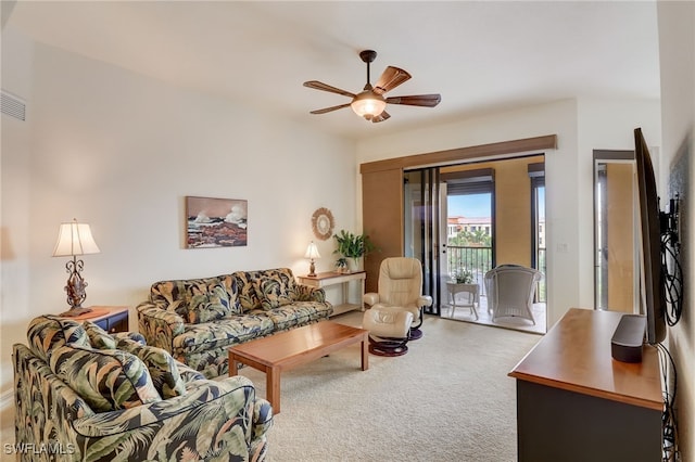 carpeted living room featuring ceiling fan