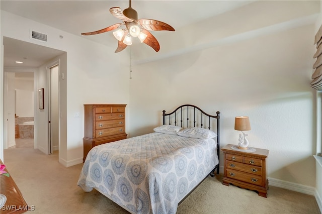 carpeted bedroom with ceiling fan and connected bathroom