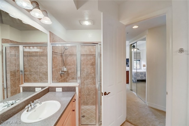 bathroom with an enclosed shower and vanity