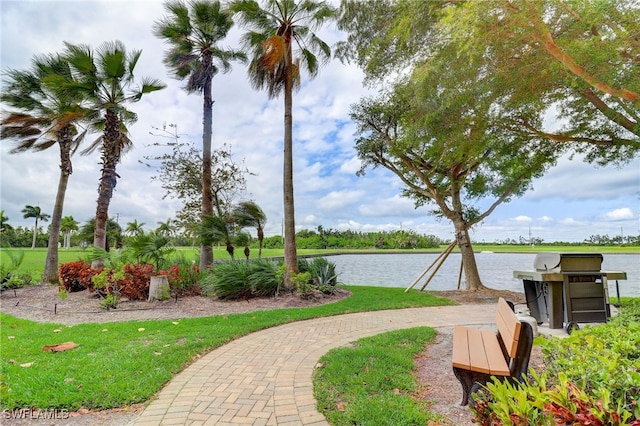 view of community featuring a yard and a water view