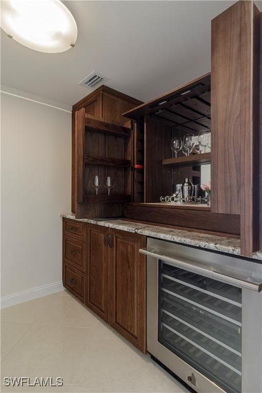 bar featuring beverage cooler and dark brown cabinets