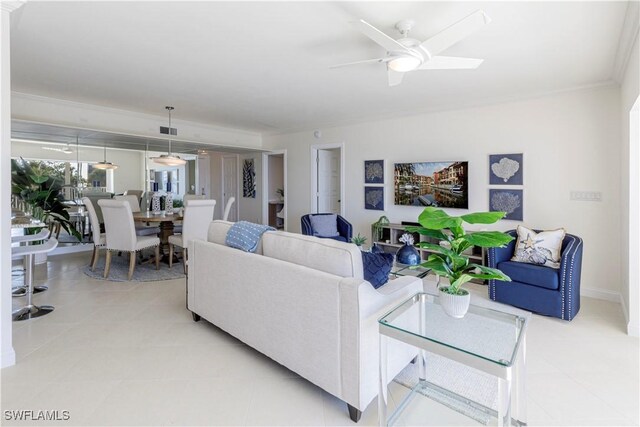 living room featuring ceiling fan and ornamental molding