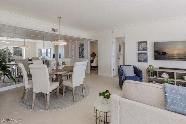 dining area with crown molding and light tile patterned flooring