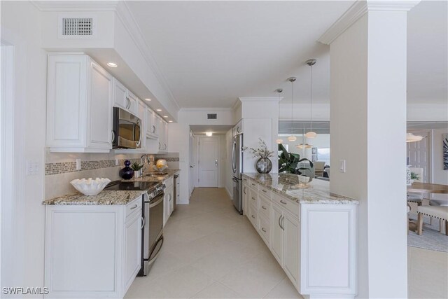 kitchen with light stone counters, crown molding, pendant lighting, stainless steel appliances, and white cabinets