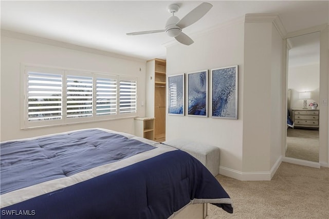 bedroom featuring ornamental molding, light carpet, and ceiling fan