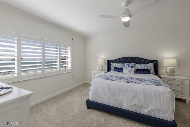 carpeted bedroom with crown molding and ceiling fan